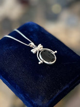 Load image into Gallery viewer, Vintage Sterling Silver Black Onyx and Mother of Pearl Double Sided Spinner Bow Motif Pendant Necklace 18”