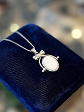 Load image into Gallery viewer, Vintage Sterling Silver Black Onyx and Mother of Pearl Double Sided Spinner Bow Motif Pendant Necklace 18”