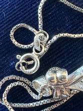 Load image into Gallery viewer, Vintage Sterling Silver Black Onyx and Mother of Pearl Double Sided Spinner Bow Motif Pendant Necklace 18”