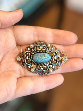 Load image into Gallery viewer, Vintage Austrian Brass Filigree Brooch Blue Rhinestones, Faux Pearls, & Blue Mottled Cabochon Center