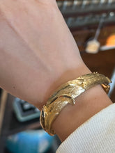 Load image into Gallery viewer, Vintage Midcentury Textured Gold Tone Wave Motif Hinged Bangle Bracelet Unsigned