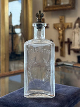 Load image into Gallery viewer, Antique 1910s Edwardian Clear Glass Holy Water Bottle Cross &amp; Leaves with Metal Crown Cap 6” Tall
