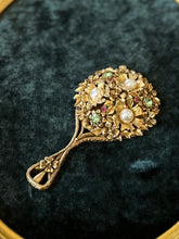 Load image into Gallery viewer, Vintage Midcentury Signed FLORENZA Gold Tone Floral Vanity Mirror Embellished with Green &amp; Pink Rhinestones and Faux Pearls
