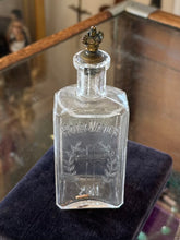 Load image into Gallery viewer, Antique 1910s Edwardian Clear Glass Holy Water Bottle Cross &amp; Leaves with Metal Crown Cap 6” Tall
