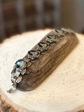 Load image into Gallery viewer, Vintage 1960s Gold Tone &amp; Black Reverse Glass Buddhist Meditation Goddess Namaste Panel Link Bracelet 7.5”
